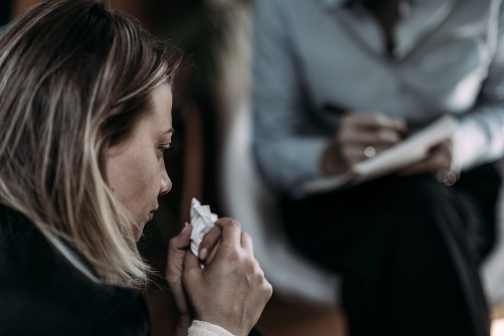 Psychotherapist Talking with Woman Suffering from PTSD.