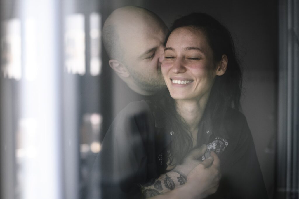 Couple in love behind windowpane