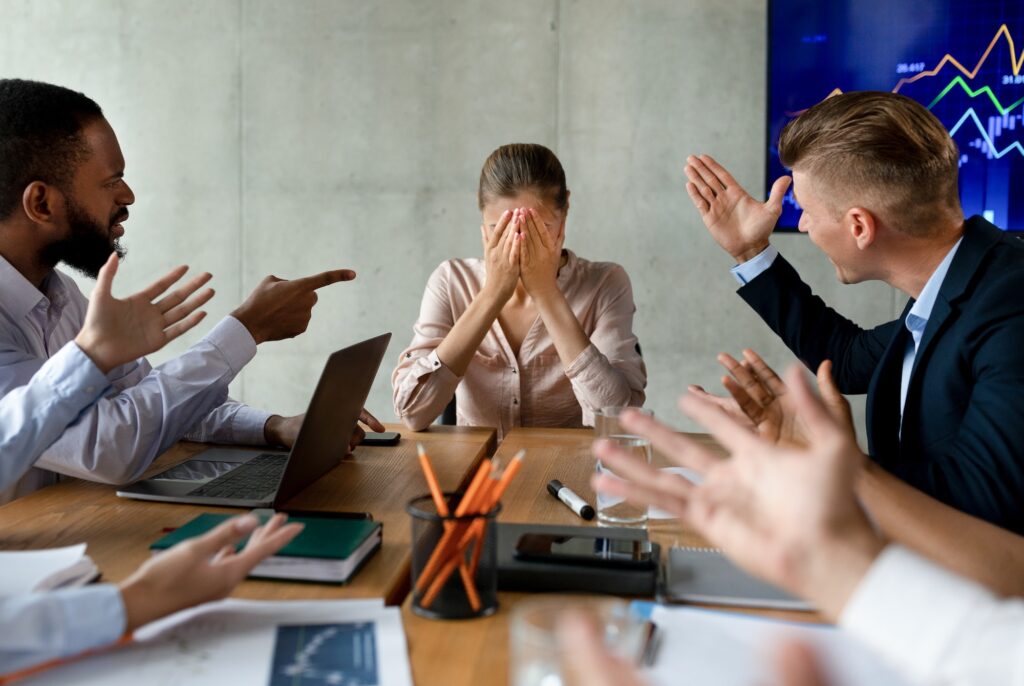 Stress At Workplace. Group Of Collagues Shouting At Female Employee In Office