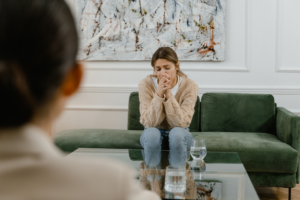 woman sitting on couch talking to therapist