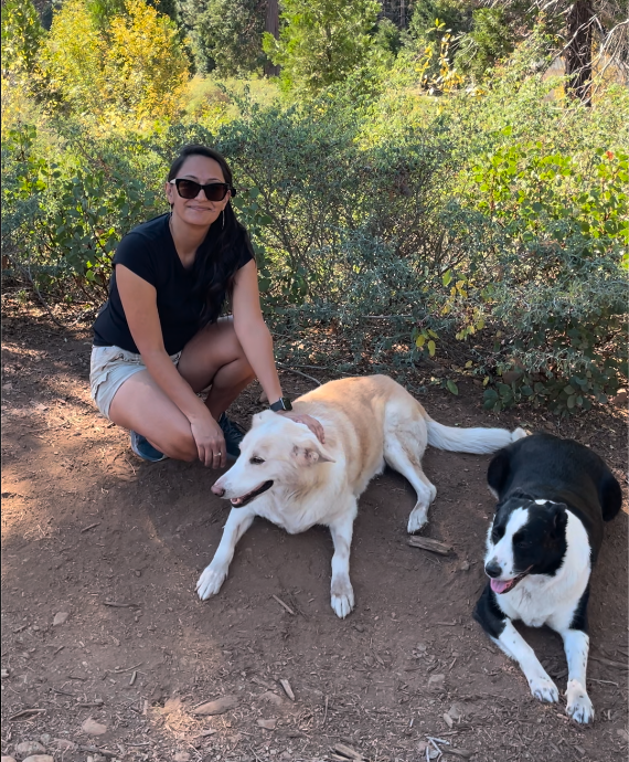 Cristeta on an outdoor trail with dogs Linus and Koda