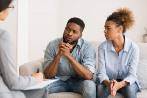 concerned African-American couple speaking to therapist