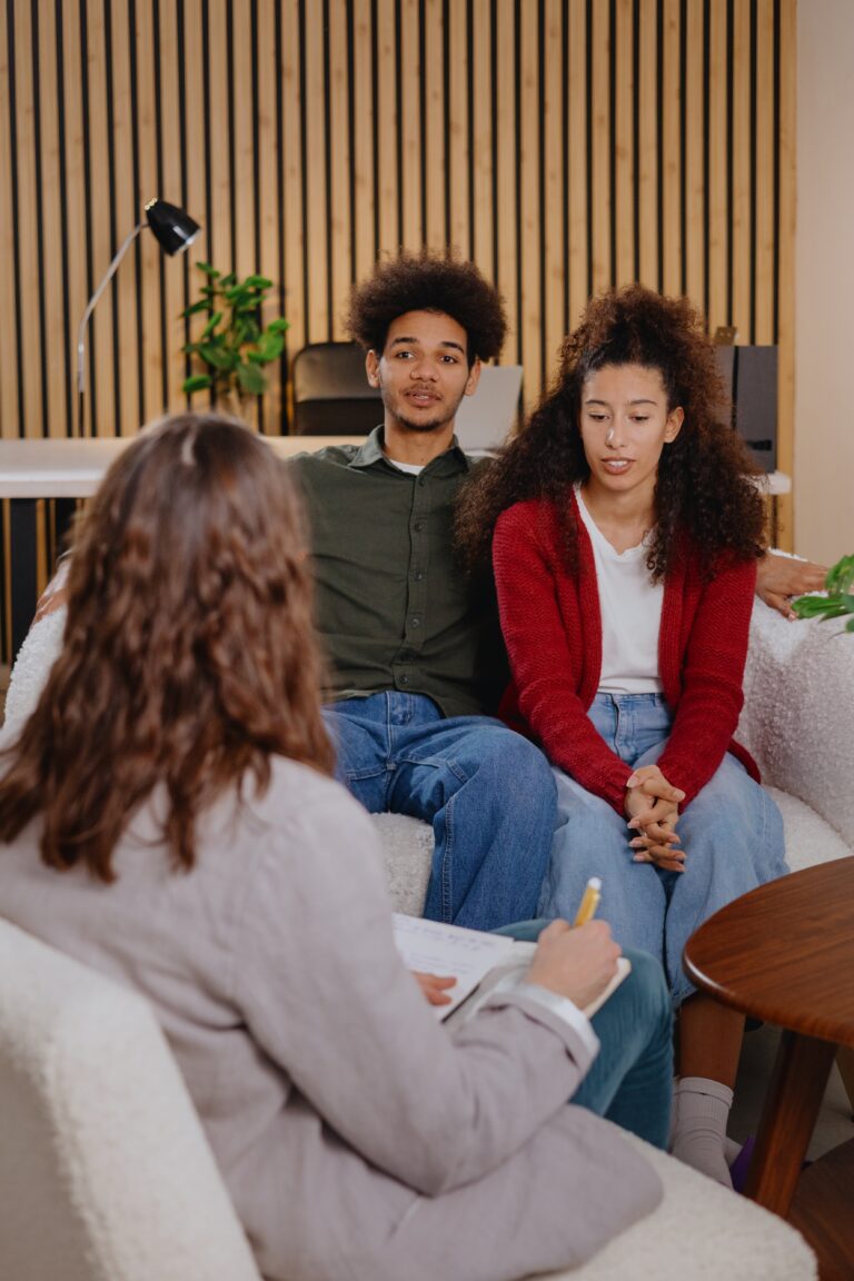 man and woman sitting with therapist during couples therapy session